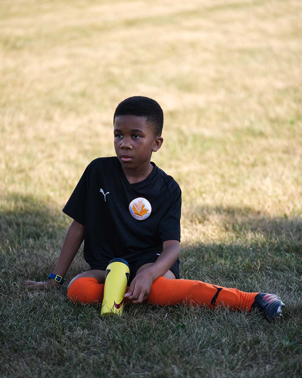Kid relaxing on a soccer field